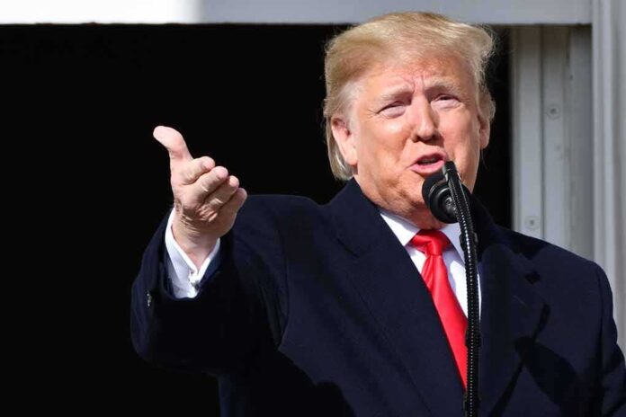 1551196565 featured image Person speaking into a microphone, gesturing with hand.