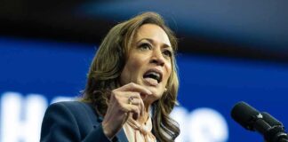 Person speaking passionately at a podium with microphone.