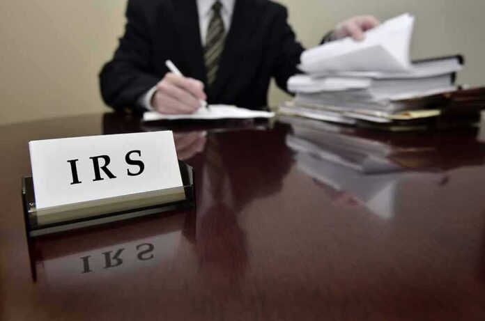 158874281 featured image IRS sign on desk with person working