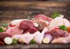 Assorted raw meat with vegetables on wooden table