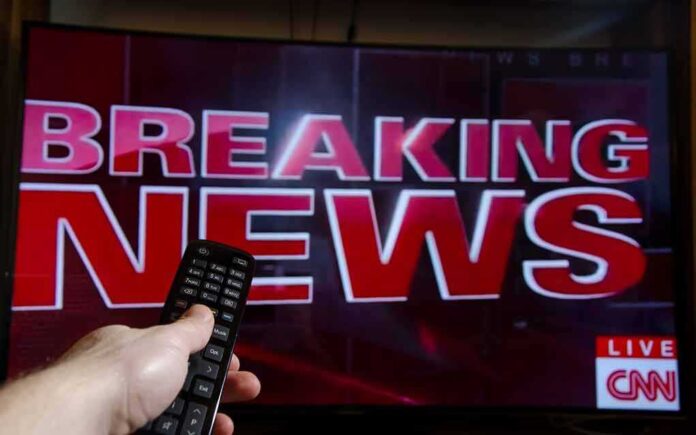 1008257860 featured image Breaking news on TV screen with remote control