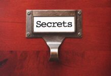 Label holder with the word Secrets on red background.