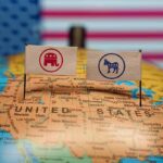 Conservatives Are Under Siege – A Deadly Game is Escalating Republican and Democratic flags on USA map background.