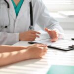 Protect Yourself from This Deadly Infection – What to Ask Your Doctor Doctor consulting patient with clipboard and pen