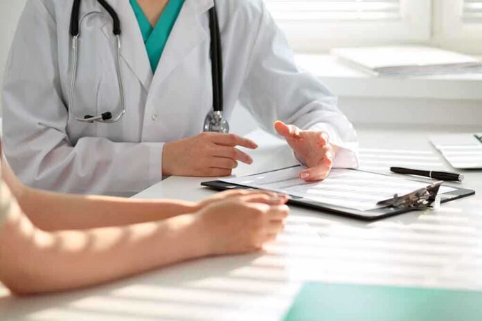 500753095 featured image Doctor consulting patient with clipboard and pen