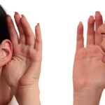 Person whispering into another persons ear gesture