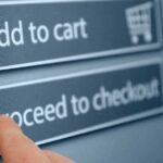 Finger tapping proceed to checkout button online