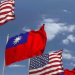 American and Taiwanese flags waving in the sky