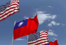 American and Taiwanese flags waving in the sky