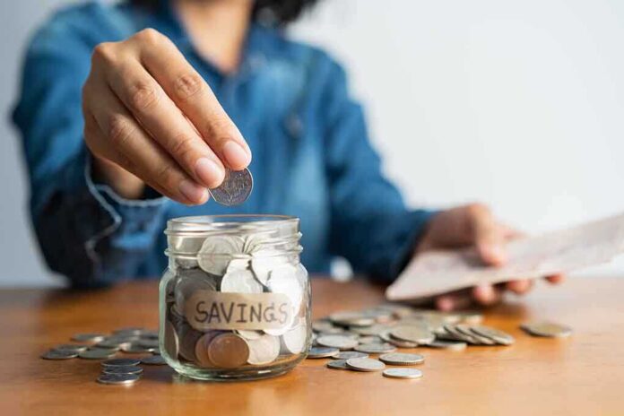1571050606 featured image Person adding coins to a savings jar
