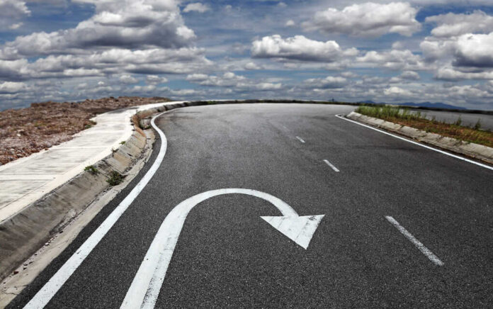158166083 featured image Curved road with a U turn arrow marking