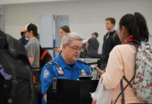 TSA agent checks passengers documents at airport security