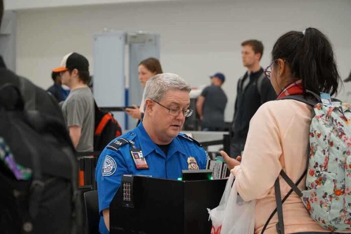 1641623299 featured image TSA agent checks passengers documents at airport security