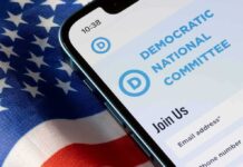 Phone displaying Democratic National Committee website over flag