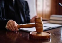 Judge holding gavel in courtroom