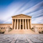 Historic building with columns under a dynamic sky.