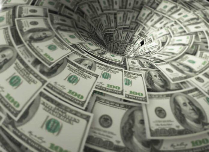 760572118 featured image Hundred-dollar bills swirling into a financial vortex
