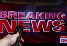 Breaking news on TV screen with remote control