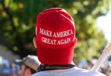 Red Make America Great Again hat on person's head.