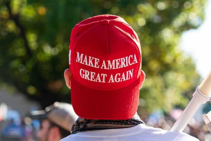 Red Make America Great Again hat on person's head.