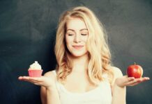 Girl looking at cupcake