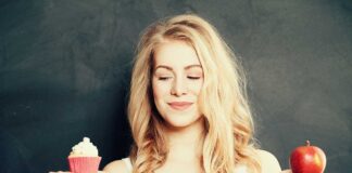 Girl looking at cupcake