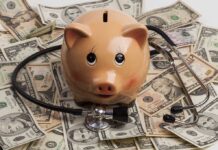Piggy bank stethoscope and money scattered around