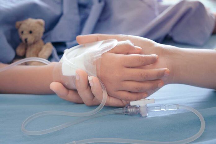 1168304533 featured image Child hand with IV held by adult