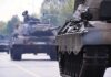 Tanks on a road with soldiers inside