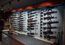 Wall display of various rifles in a gun store