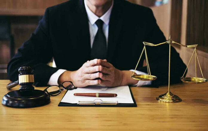 1092414422 Person in suit with gavel and scales of justice