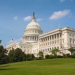 Senate CONFIRMS Kent — Left in PANIC The US Capitol building surrounded by green grass and trees under a blue sky