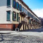 HUD’s English-Only Policy Hits Millions Overnight Row houses along a cobblestone street in an urban setting