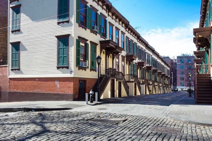 Row houses along a cobblestone street in an urban setting