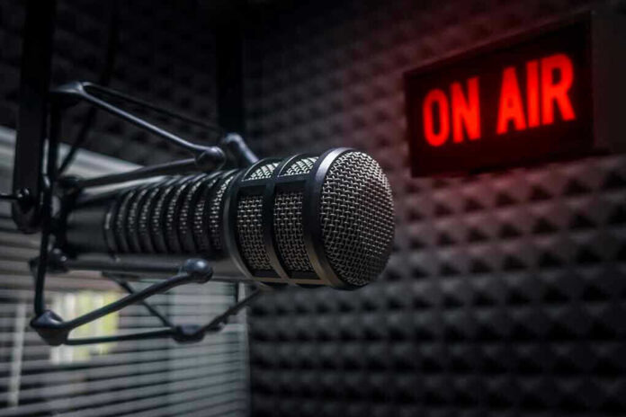 Radio microphone in studio with On Air sign.
