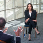 Kamala Unleashes Chaos – DROPS TRUTH BOMB! Two people having a formal discussion in office.