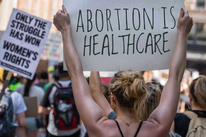 Protestors holding signs about womens rights and healthcare.