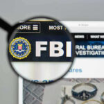 FBI website shown through magnifying glass.