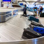 Luggage on a conveyor belt at an airport baggage claim area