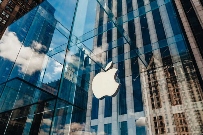 Apple store with glass facade and city reflections.