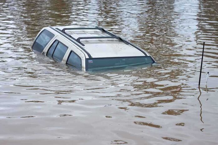shutterstock_68552284.jpg A partially submerged vehicle in floodwaters