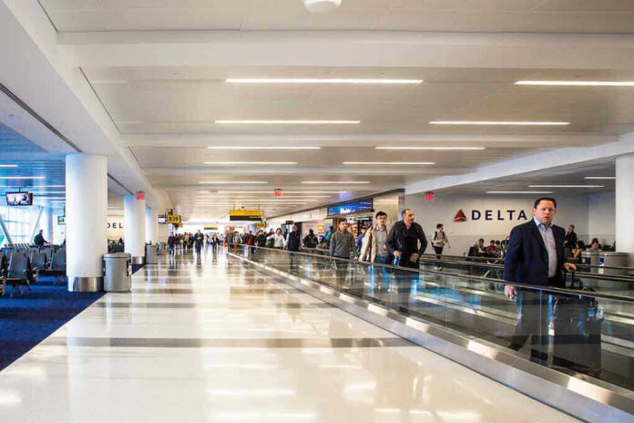 People walking through an airport terminal.