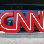 CNN Fact-Checks Ghetto Rep – She’s STUNNED! Large red CNN sign outside building entrance.