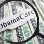 Magnifying glass over Obamacare text and money