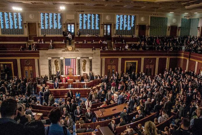 shutterstock_1186368289.jpg A crowded congressional chamber with members in discussion
