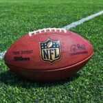 NFL Star Gunned Down – In Critical Condition An NFL football resting on a green grass field