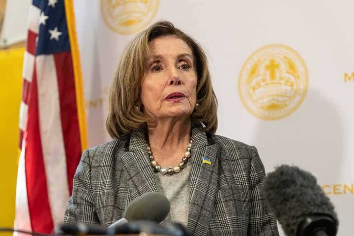 A female politician speaking at a press conference with an American flag in the background