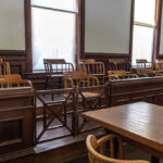 Empty jury box and table in courtroom.