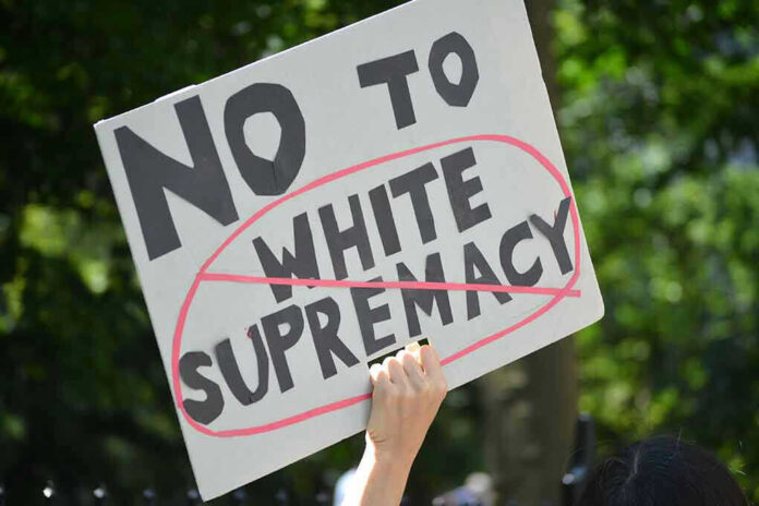 657670060 Sign saying No to white supremacy with red circle.
