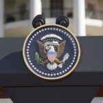Close-up of the presidential seal on a podium